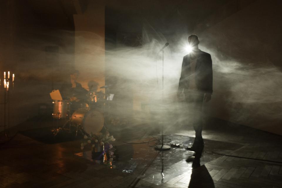 performer stepping on stage in smoke