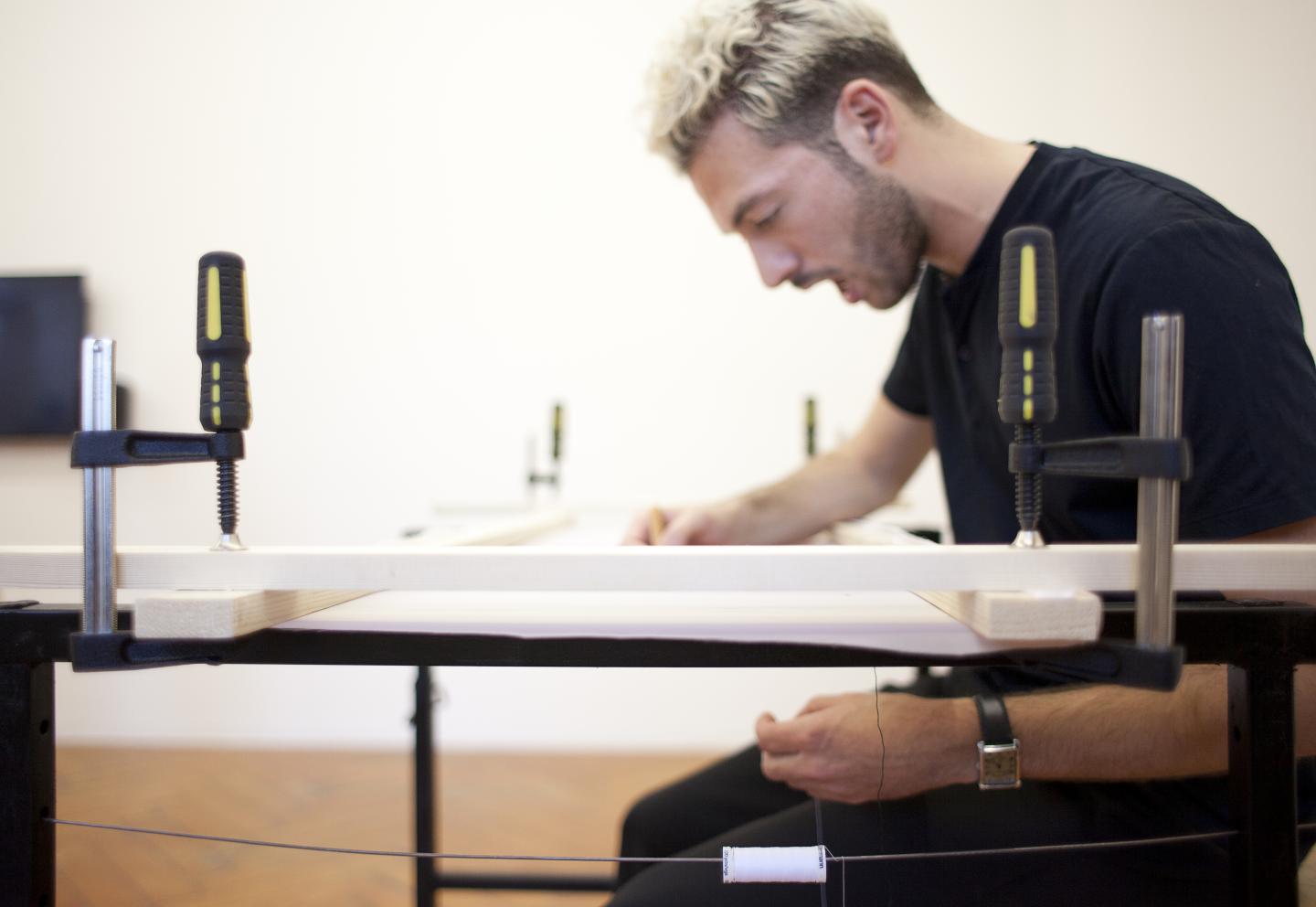 artist doing embroidery and singing